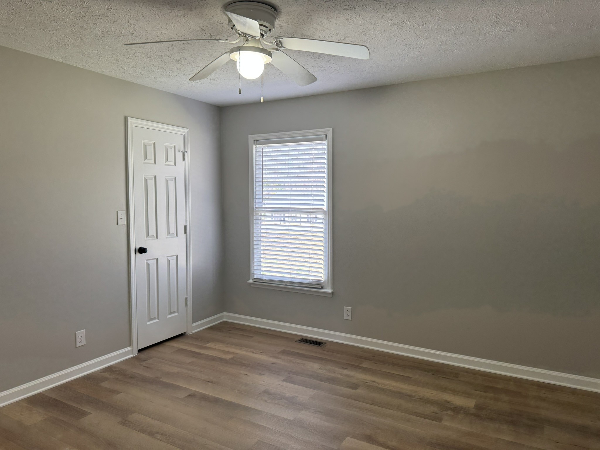 226 Nottingham Road Dickson, TN 37055 - Photo 10 of 17 an empty room with wooden floor chandelier fan and windows