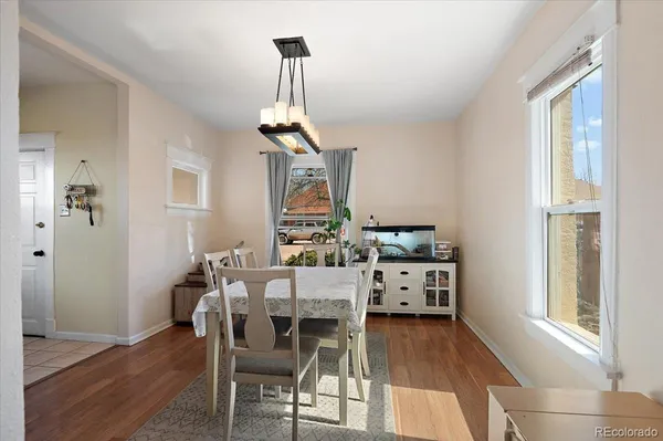 a view of a dining room with furniture wooden floor and chandelier