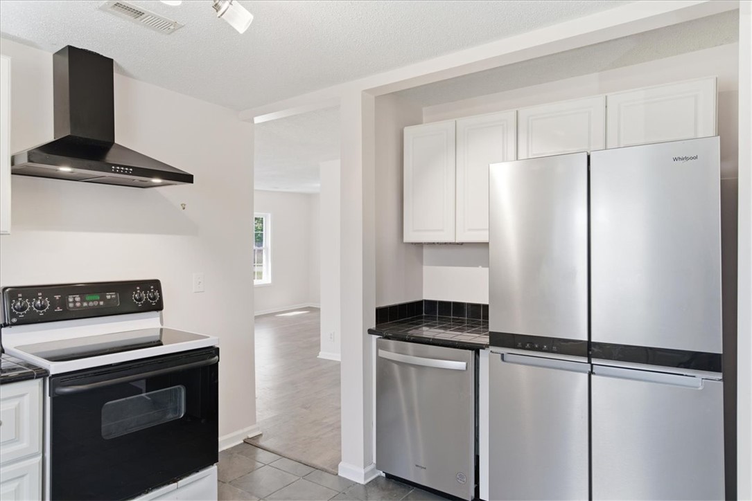 112 Newry Road Seneca, SC 29672 - Photo 8 of 19 This sleek kitchen features modern appliances and an open layout, ideal for everyday living.