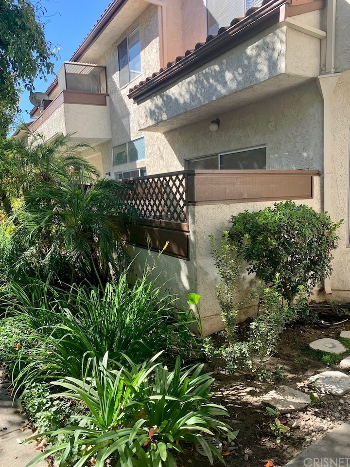 1736 Sinaloa Road, Unit 318 Simi Valley, CA 93065 - Photo 1 of 1 a front view of a house with a yard