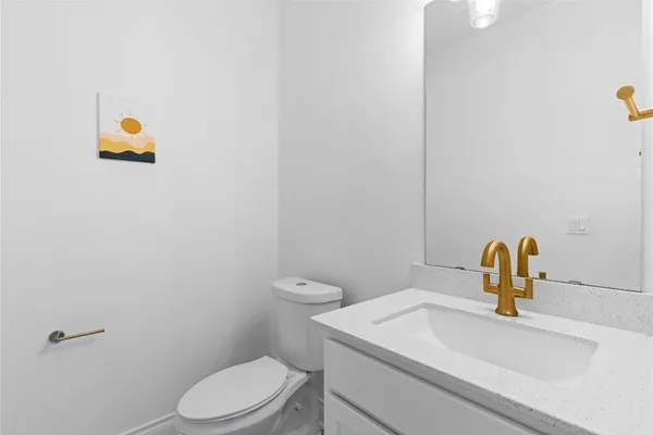 a bathroom with a sink a toilet and mirror