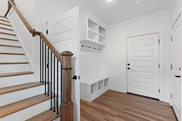a view of an entryway with wooden floor