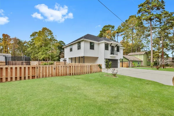 a view of a house with a small yard and a garden