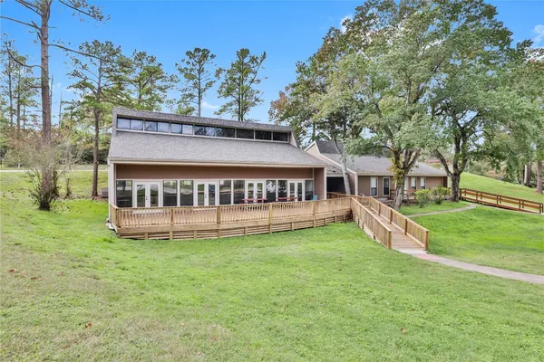 a view of a house with a yard and a fountain