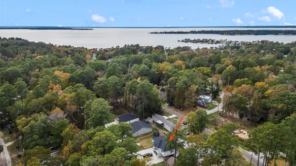 an aerial view of a houses with a lake view