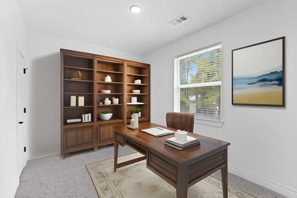 a view of a workspace with furniture