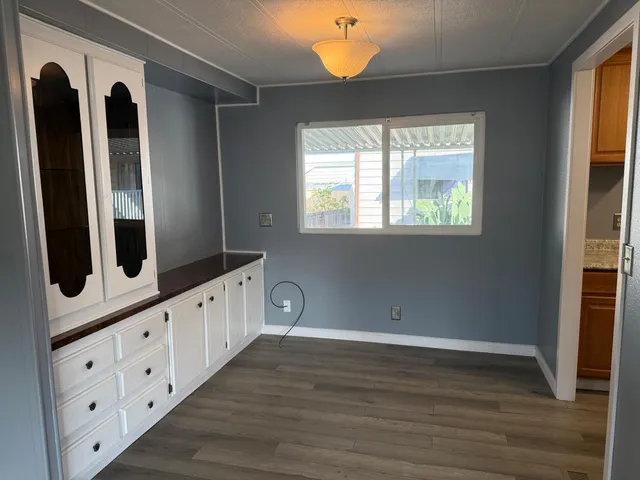 a kitchen with cabinets a sink and a window