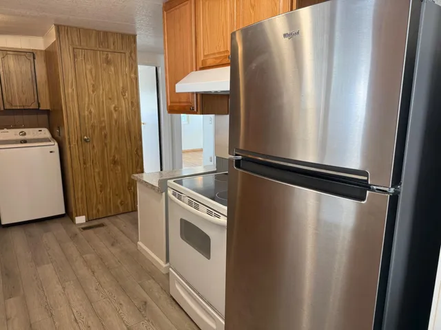 a view of a refrigerator with washer and dryer