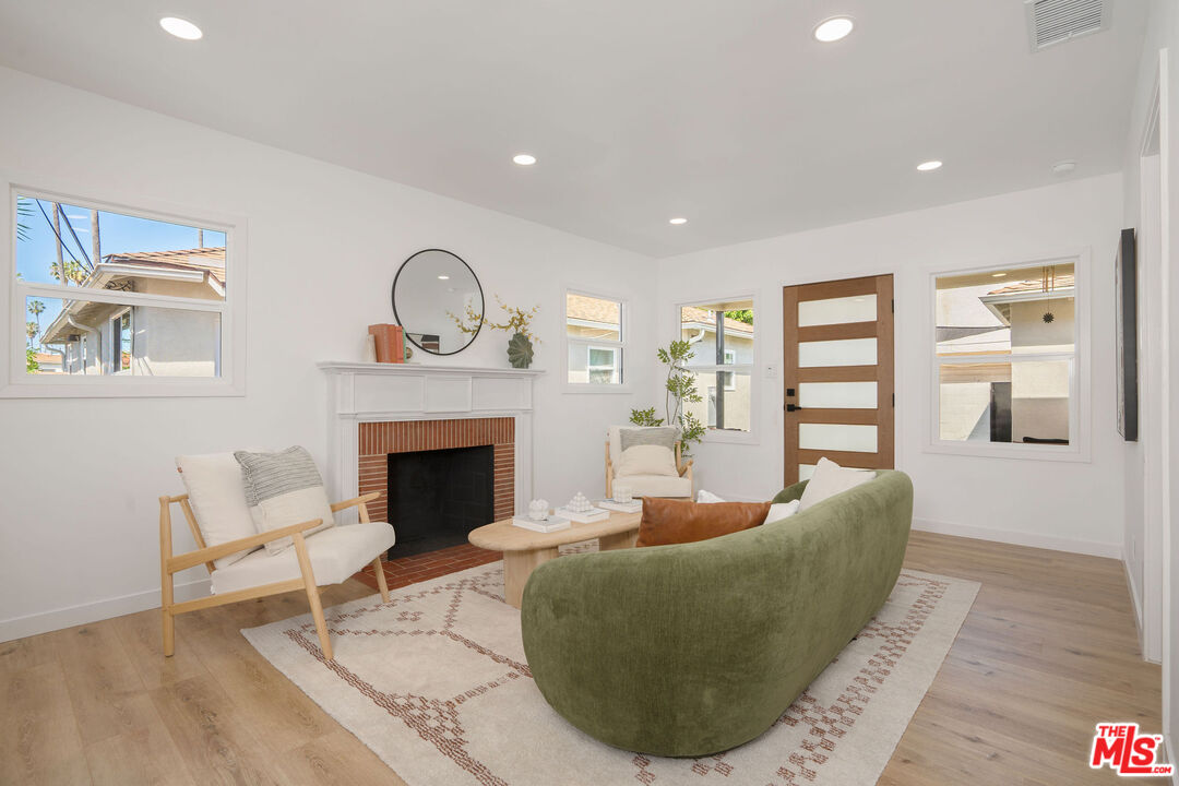 5418 South Rimpau Boulevard Los Angeles, CA 90043 - Photo 16 of 23 a living room with furniture and a fireplace