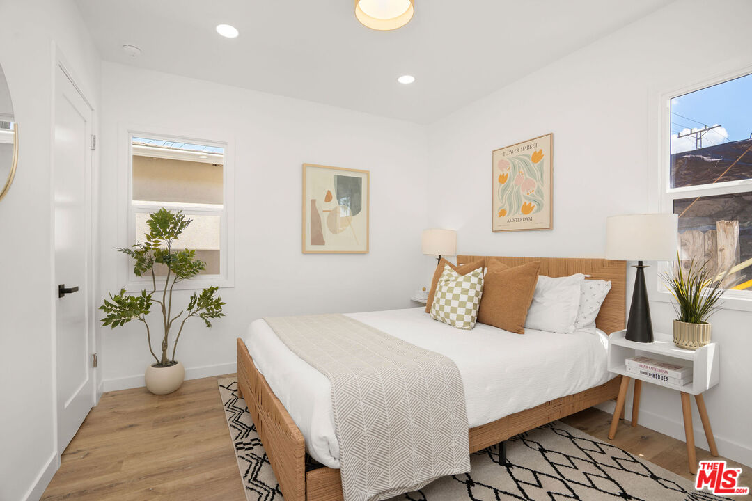 5418 South Rimpau Boulevard Los Angeles, CA 90043 - Photo 21 of 23 a bedroom with a bed and a potted plant