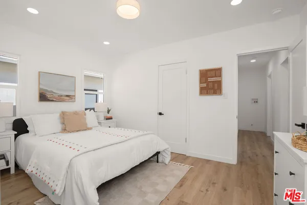 a bedroom with a bed and a painting on the wall