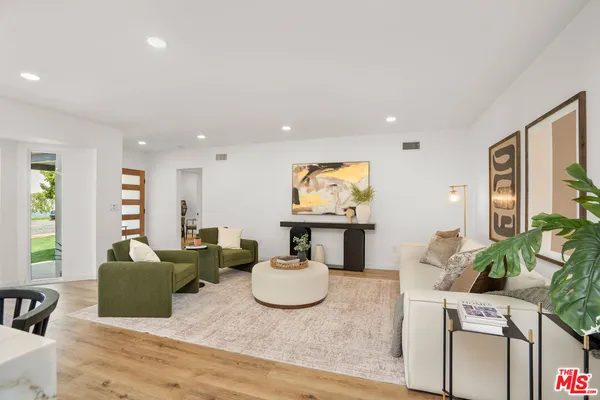 a living room with furniture a flat screen tv and a large window