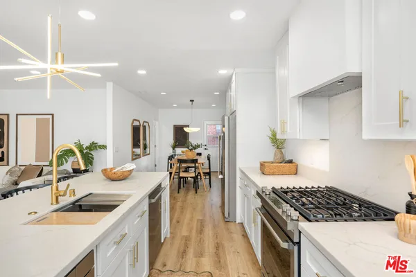 a kitchen with a sink stove and cabinets