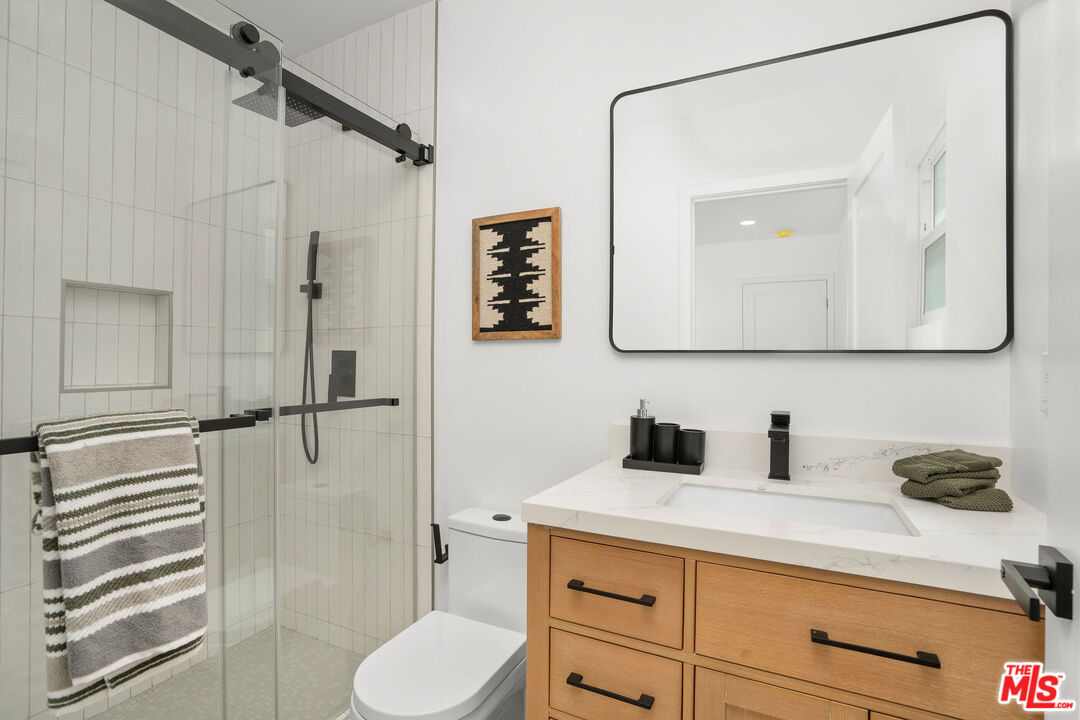 5418 South Rimpau Boulevard Los Angeles, CA 90043 - Photo 9 of 23 a bathroom with a sink a toilet and shower