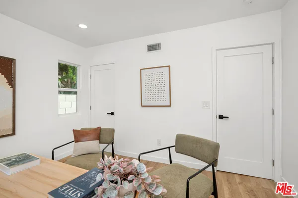 a bedroom with furniture and a window