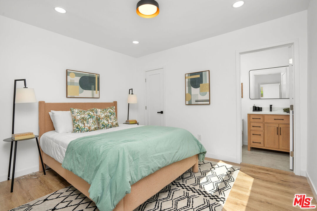 5418 South Rimpau Boulevard Los Angeles, CA 90043 - Photo 10 of 23 a bedroom with a bed and a couch