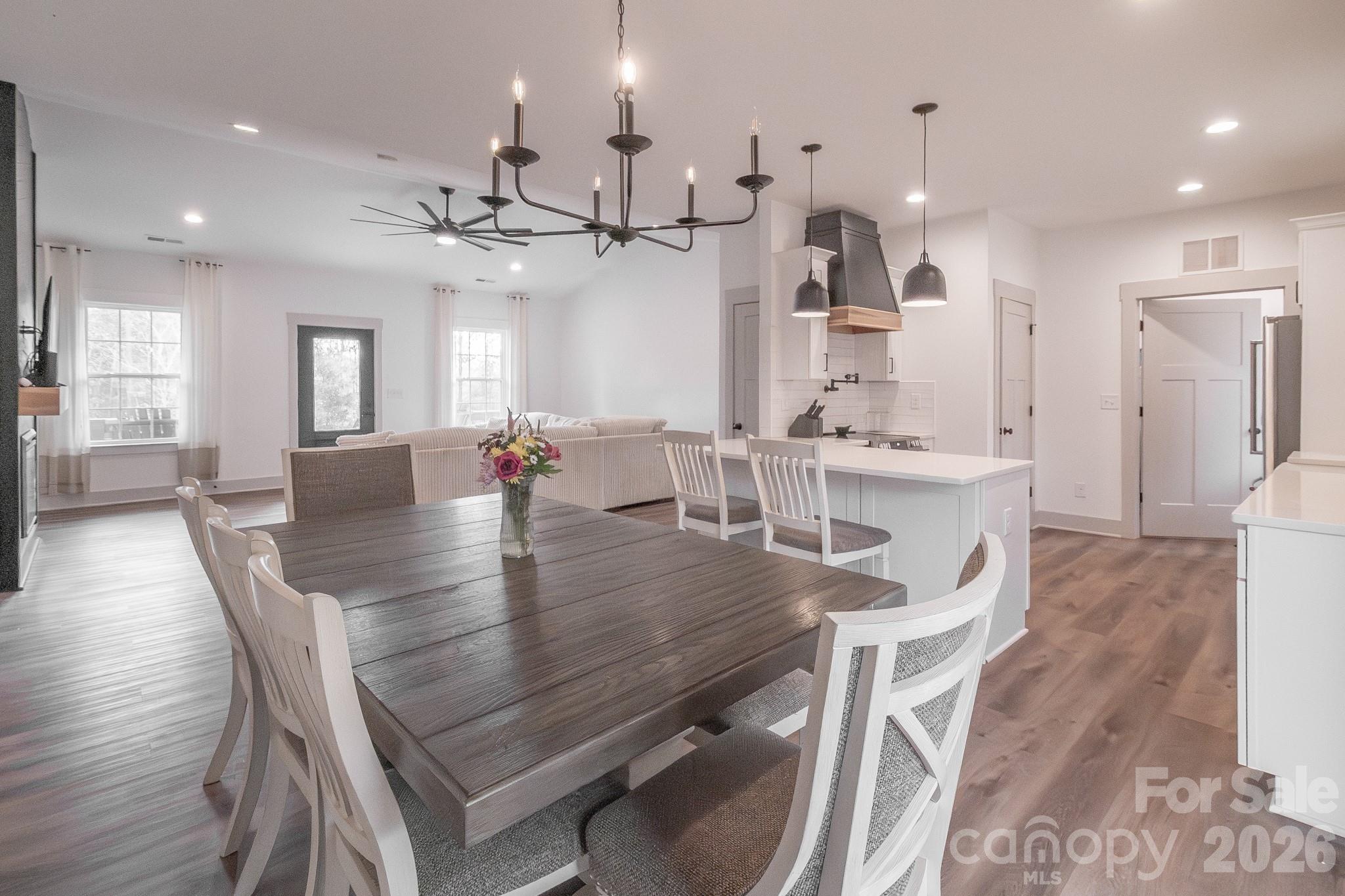 731 Miles Road Dallas, NC 28034 - Photo 13 of 45 a dining room with kitchen island furniture a chandelier and kitchen view