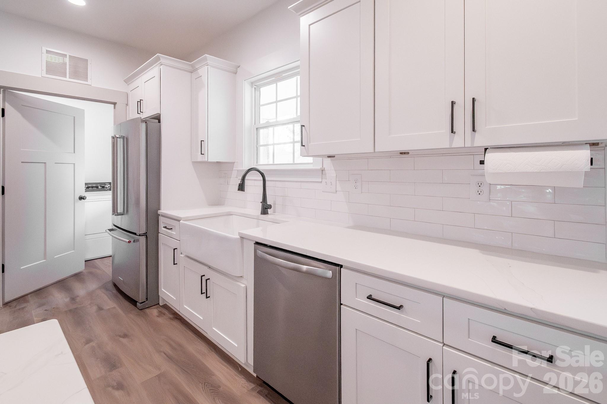 731 Miles Road Dallas, NC 28034 - Photo 17 of 45 a kitchen with stainless steel appliances a sink stove and cabinets