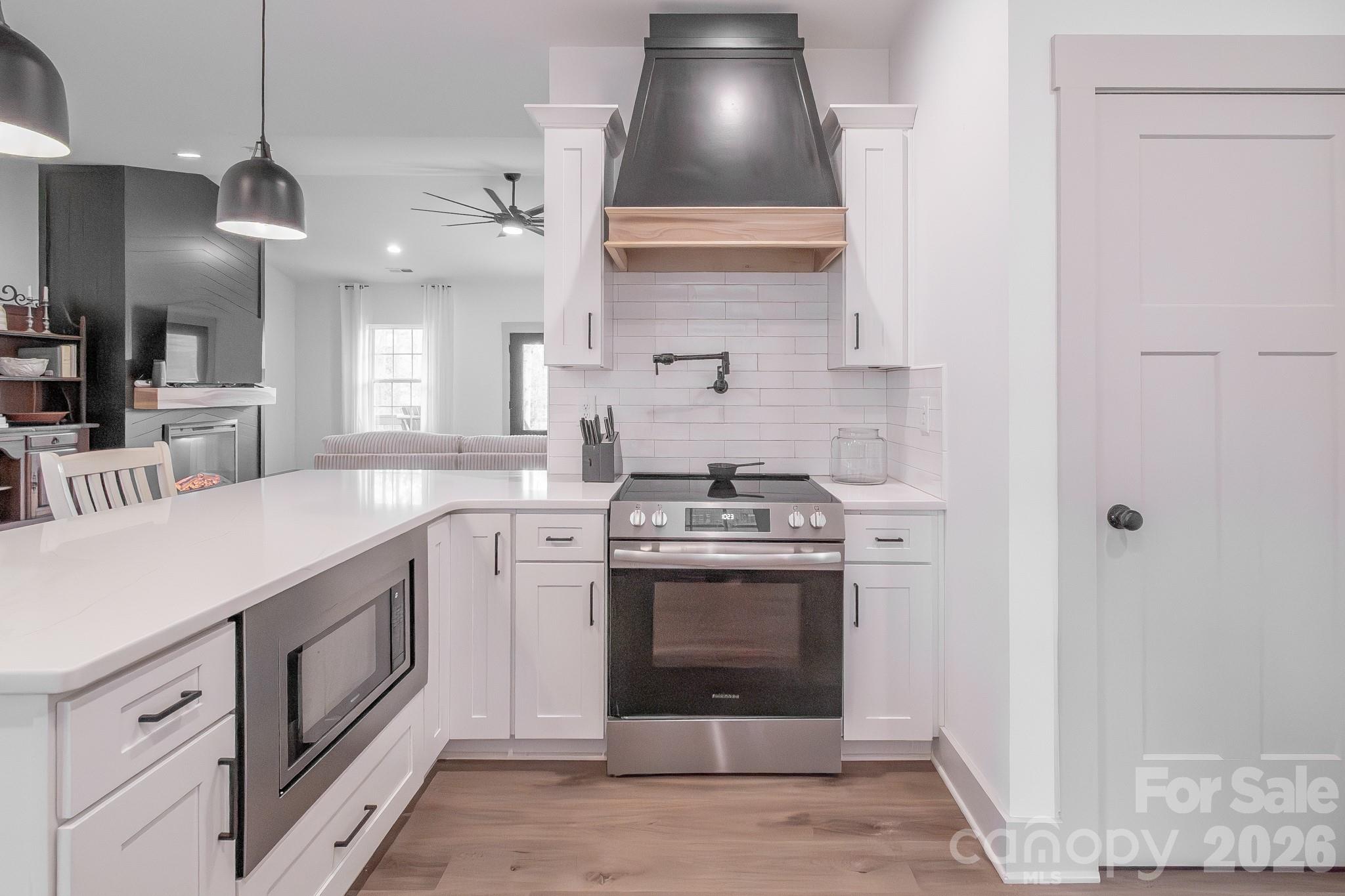731 Miles Road Dallas, NC 28034 - Photo 18 of 45 a kitchen with stainless steel appliances granite countertop a stove a sink and a refrigerator