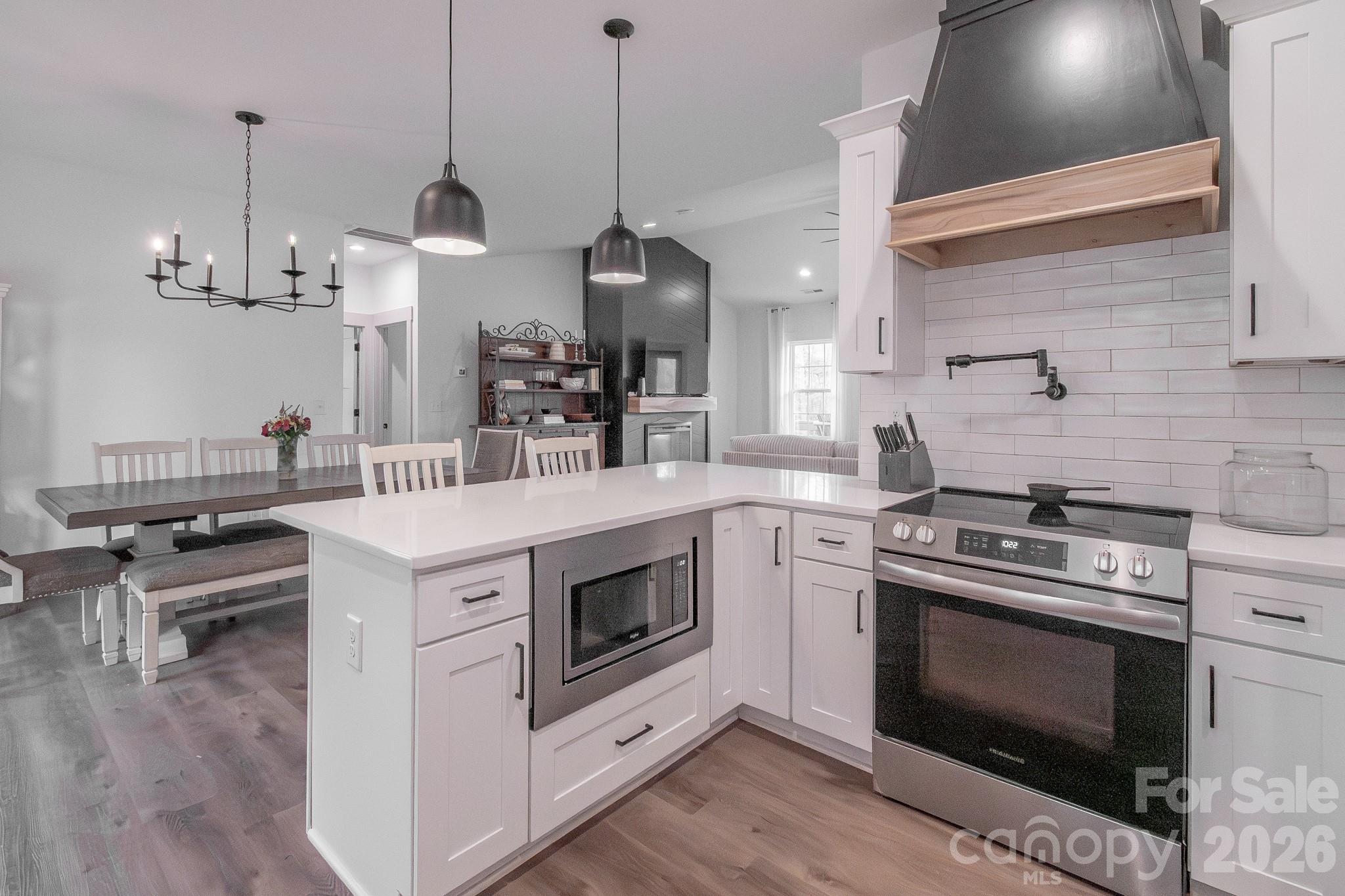 731 Miles Road Dallas, NC 28034 - Photo 19 of 45 a kitchen with a stove and a wooden floor