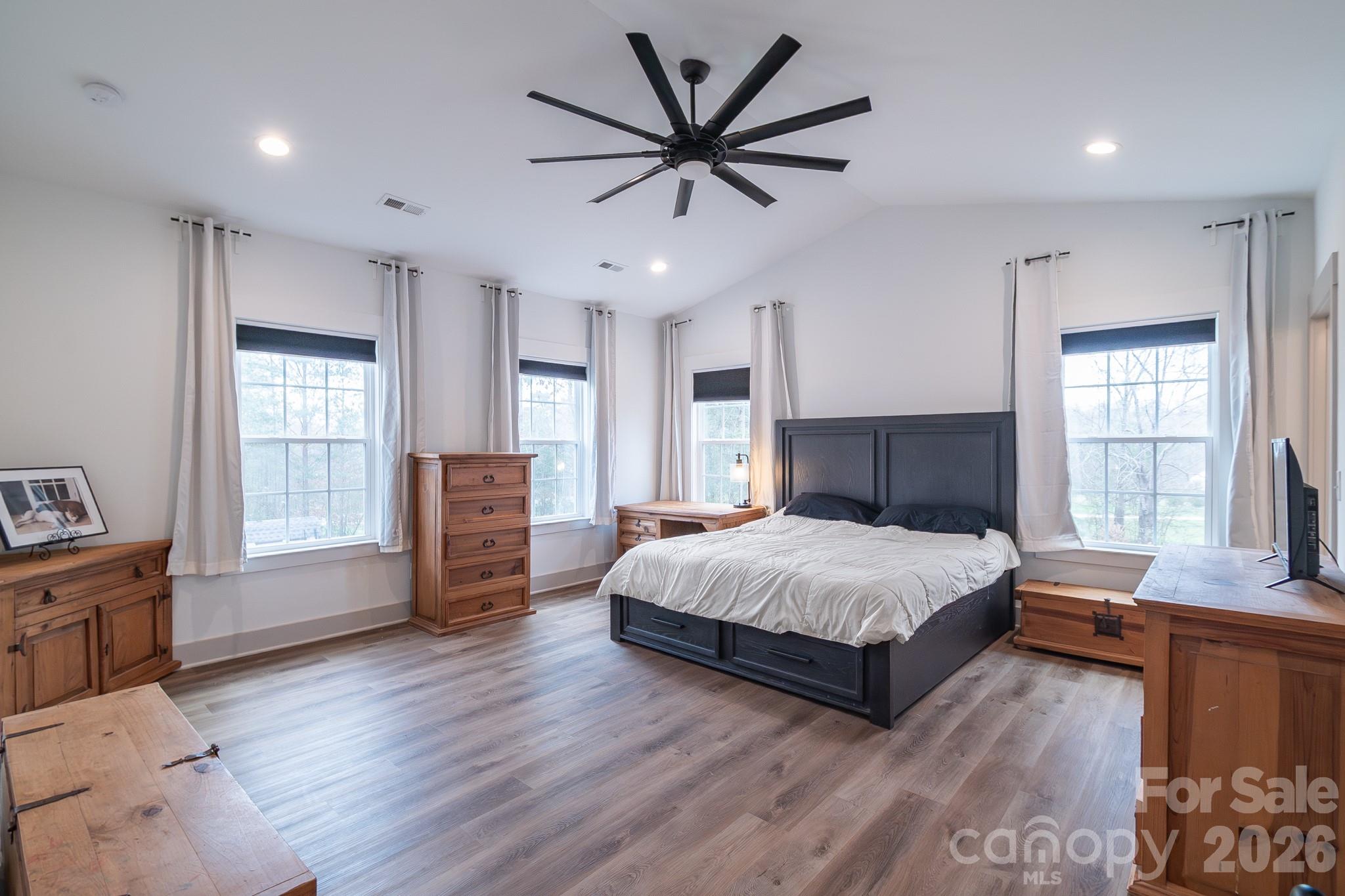 731 Miles Road Dallas, NC 28034 - Photo 21 of 45 a spacious bedroom with a large bed and a large window