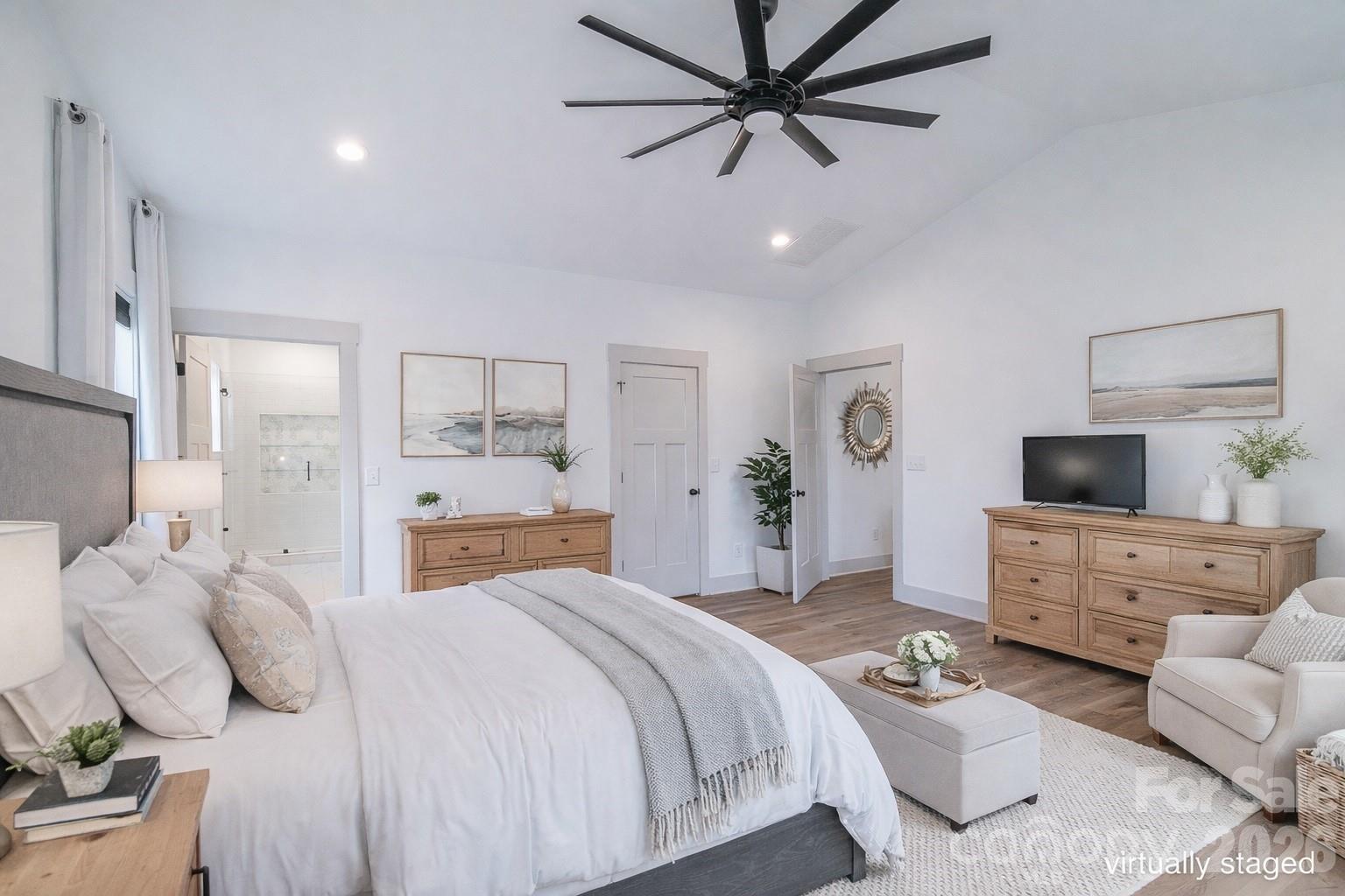 731 Miles Road Dallas, NC 28034 - Photo 22 of 45 a bedroom with bed a couch and a flat screen tv