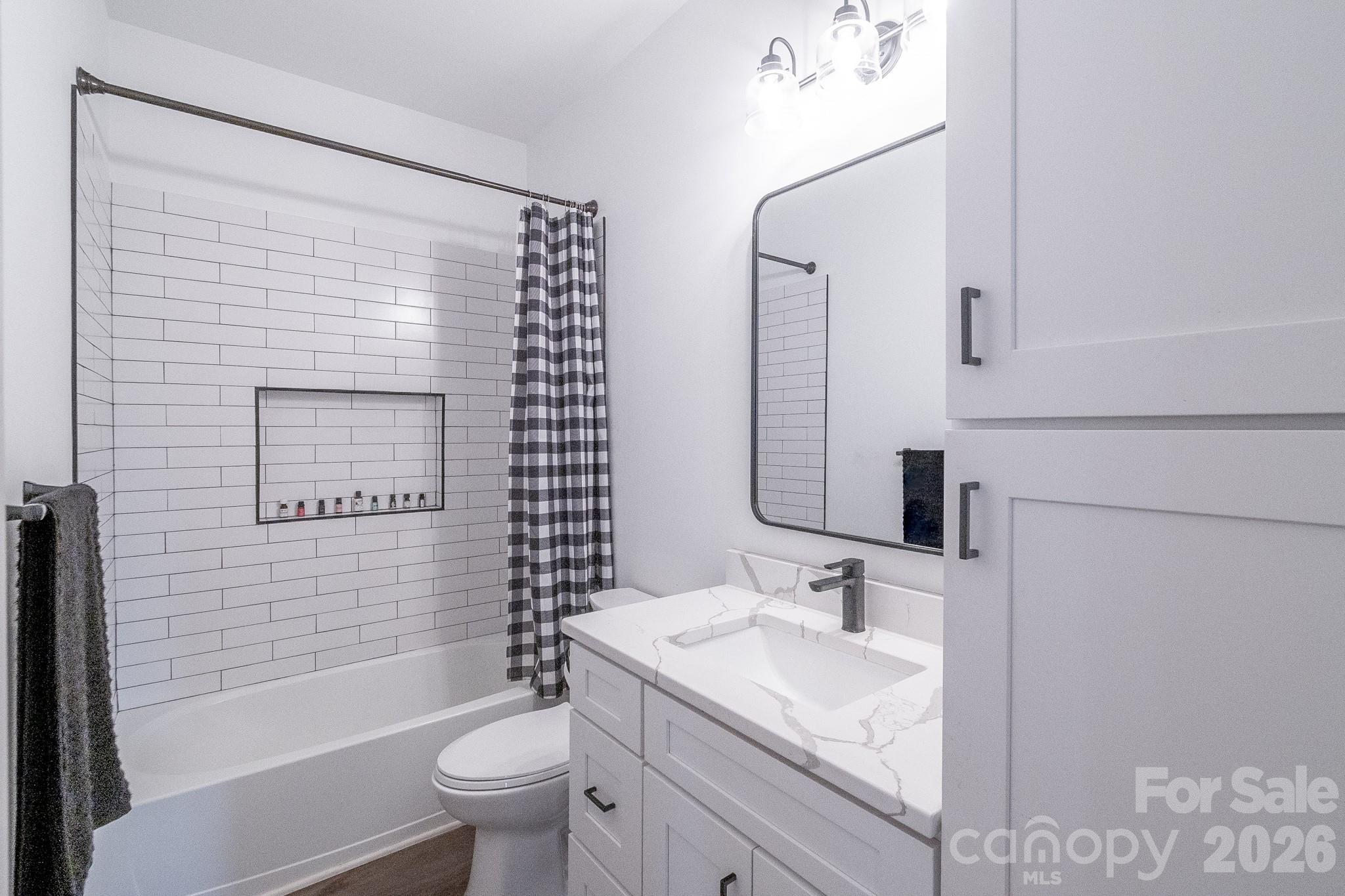 731 Miles Road Dallas, NC 28034 - Photo 33 of 45 a bathroom with a granite countertop sink toilet and shower