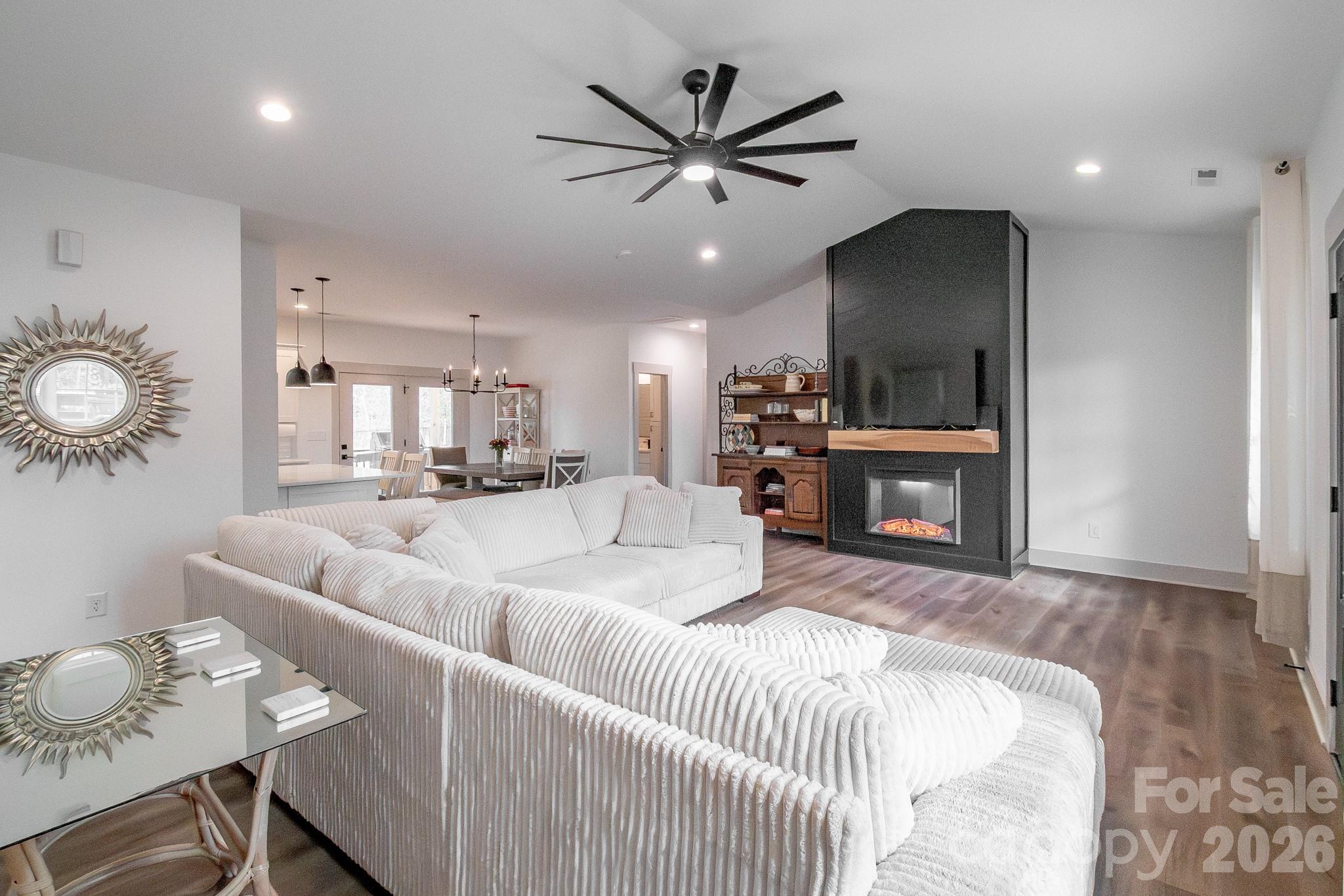 731 Miles Road Dallas, NC 28034 - Photo 9 of 45 a living room with furniture a fireplace and a flat screen tv