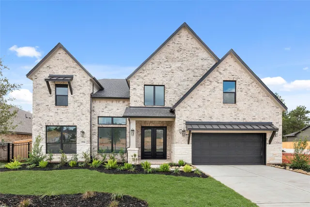 a front view of a house with a garden and yard