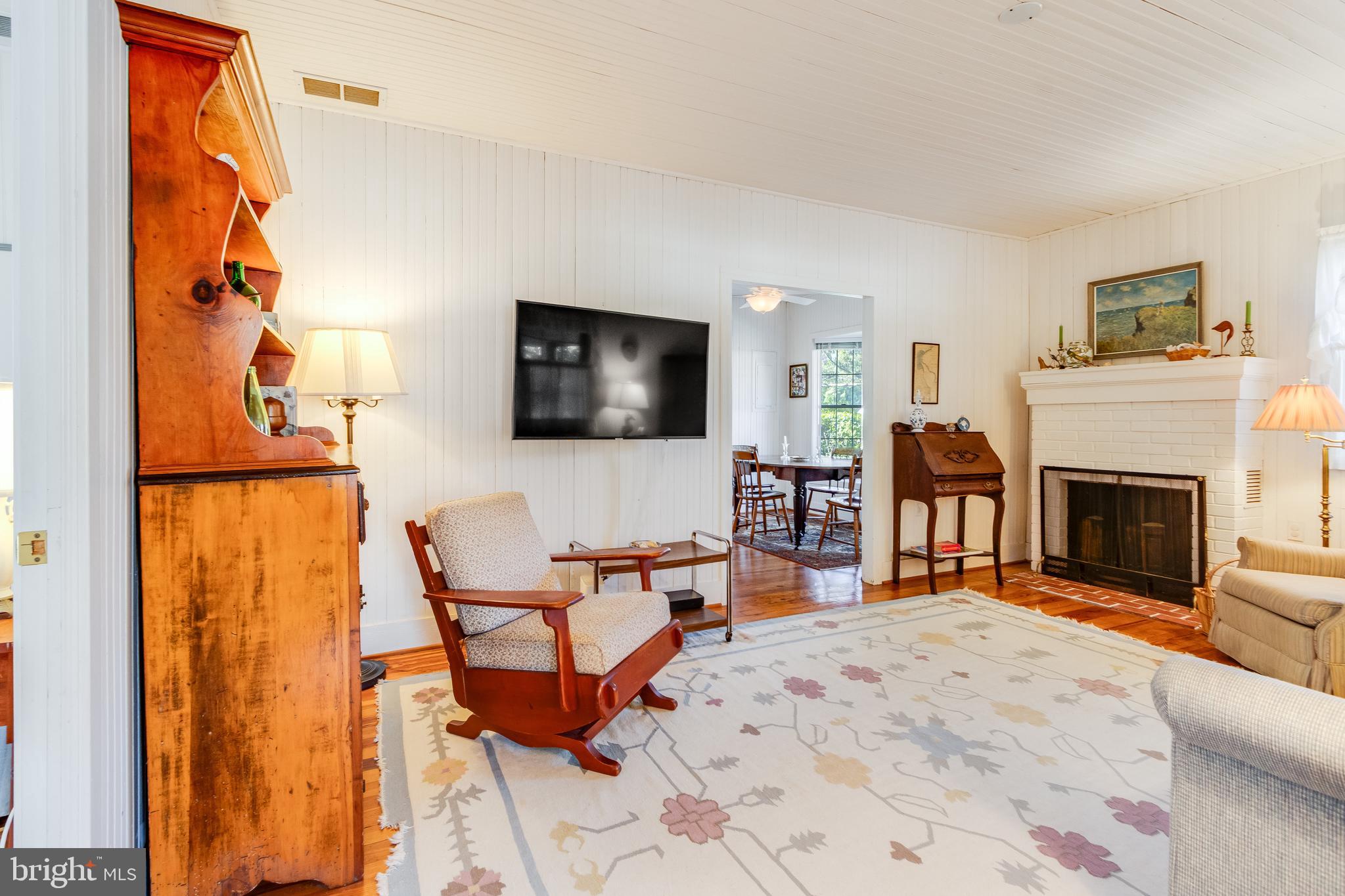28 Delaware Avenue Rehoboth Beach, DE 19971 - Photo 18 of 44 a living room with furniture a flat screen tv and a fireplace