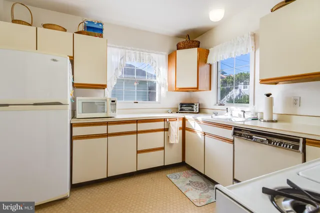 a kitchen with stainless steel appliances granite countertop a sink and a stove