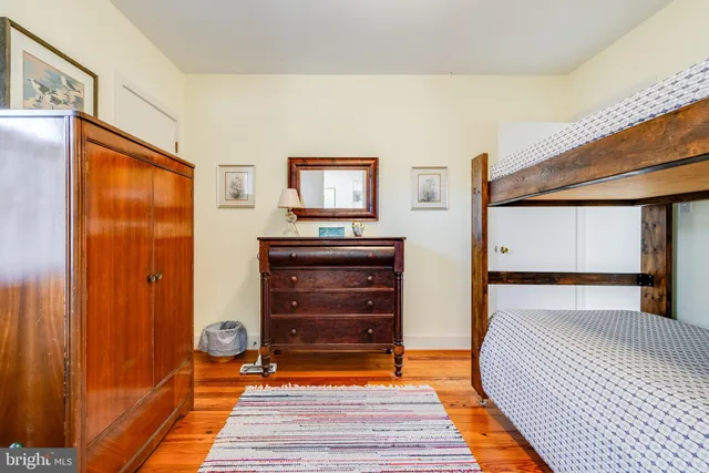 a bedroom with a bed and a mirror