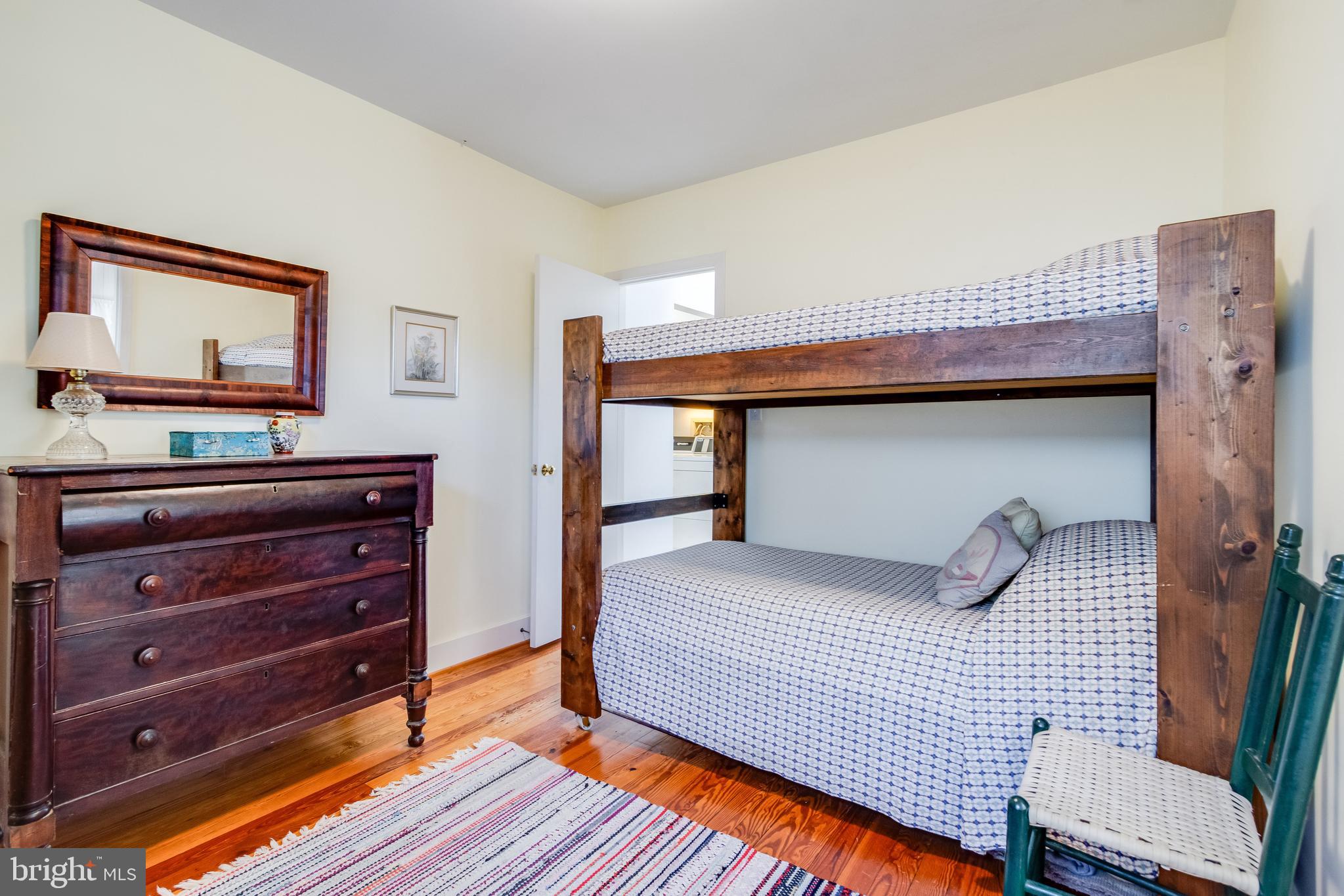 28 Delaware Avenue Rehoboth Beach, DE 19971 - Photo 37 of 44 a bedroom with a bed and a mirror