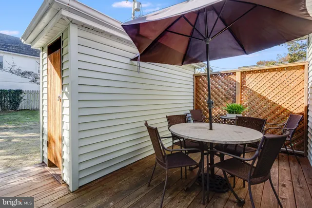 a view of a patio with table and chairs and wooden floor