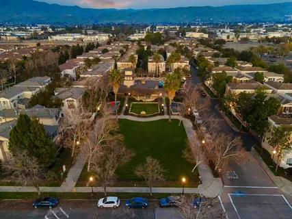 an aerial view of a swimming pool with outdoor seating