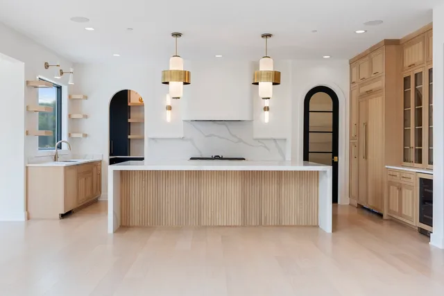 a kitchen with a sink and large window