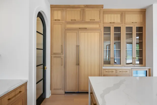 a view of a kitchen with white cabinets