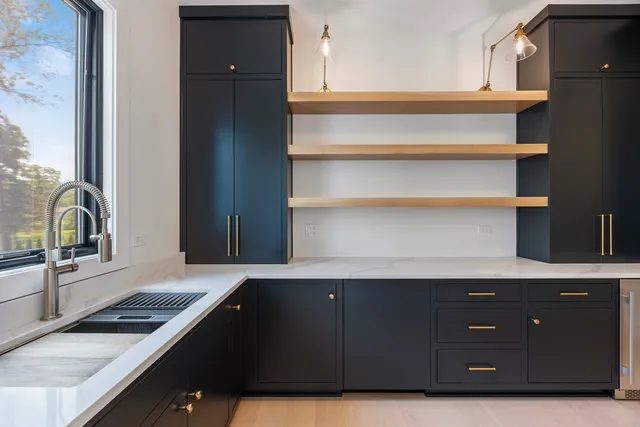 a view of a hallway with wooden floor and windows