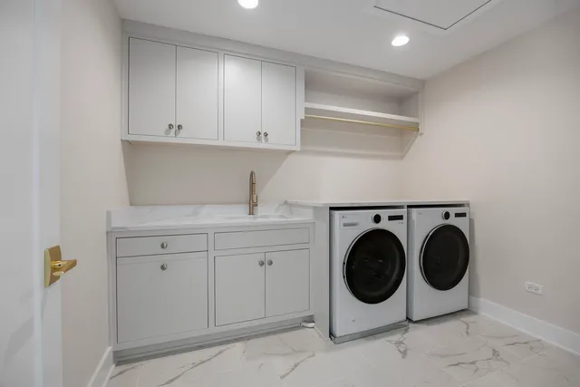 a spacious bathroom with a double vanity sink a large mirror and a shower