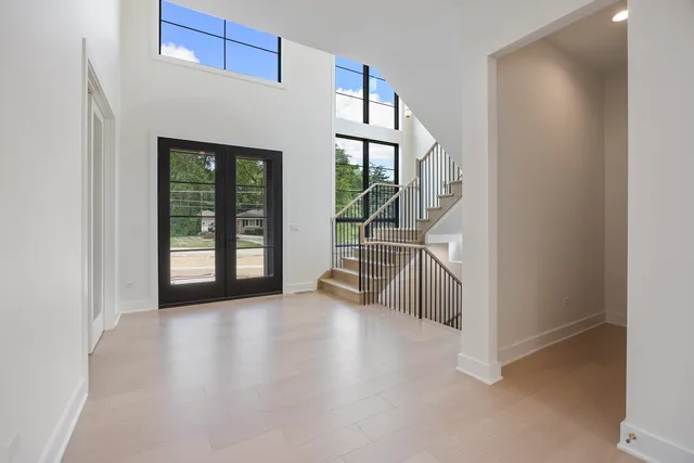 an entryway with chandelier and a kitchen