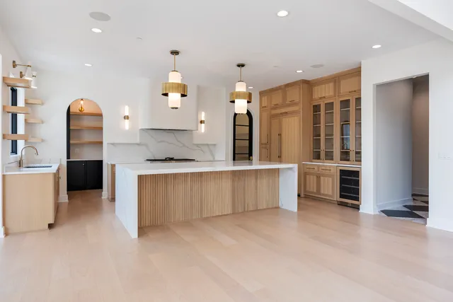 a large kitchen with granite countertop a white stove top oven and sink
