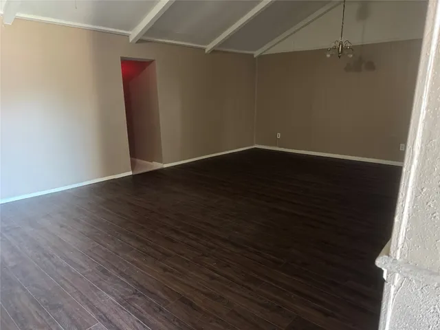 a view of a room with wooden floor and fan