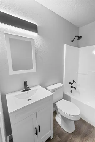 a bathroom with a toilet a sink and mirror