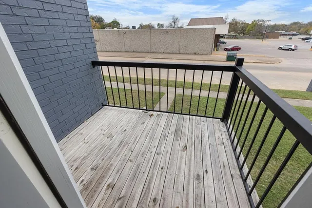 a view of balcony with wooden floor