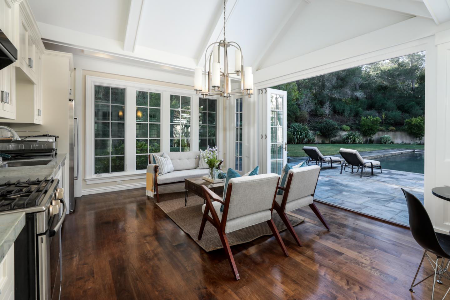 1 Sutherland Drive Atherton, CA 94027 - Photo 14 of 32 a living room with fireplace furniture and a chandelier