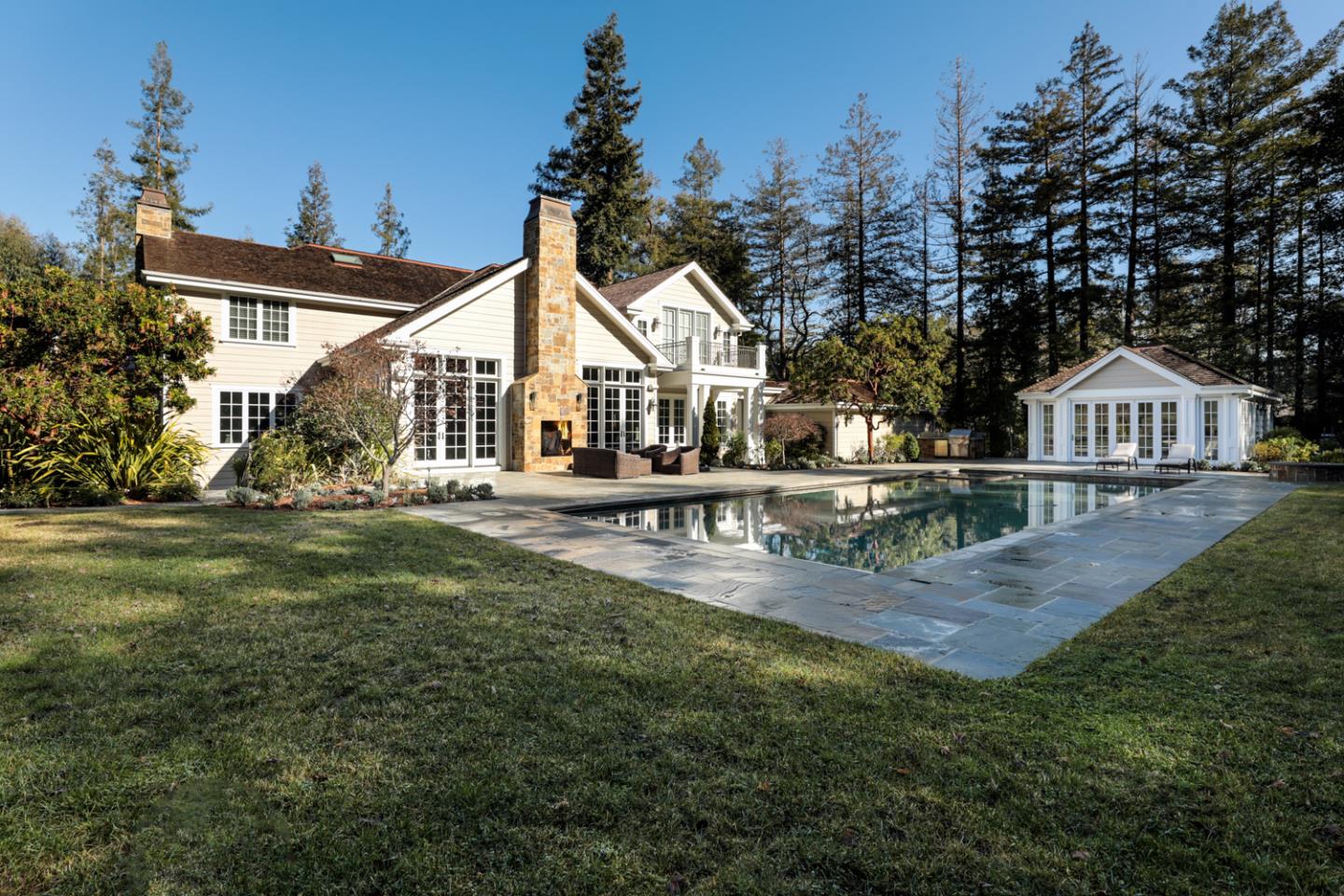 1 Sutherland Drive Atherton, CA 94027 - Photo 2 of 32 a view of a house next to a yard with potted plants and large trees