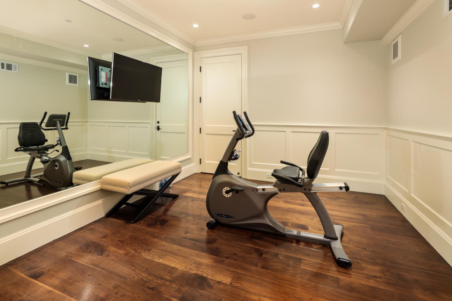 1 Sutherland Drive Atherton, CA 94027 - Photo 25 of 32 a living room with furniture gym equipment and a flat screen tv