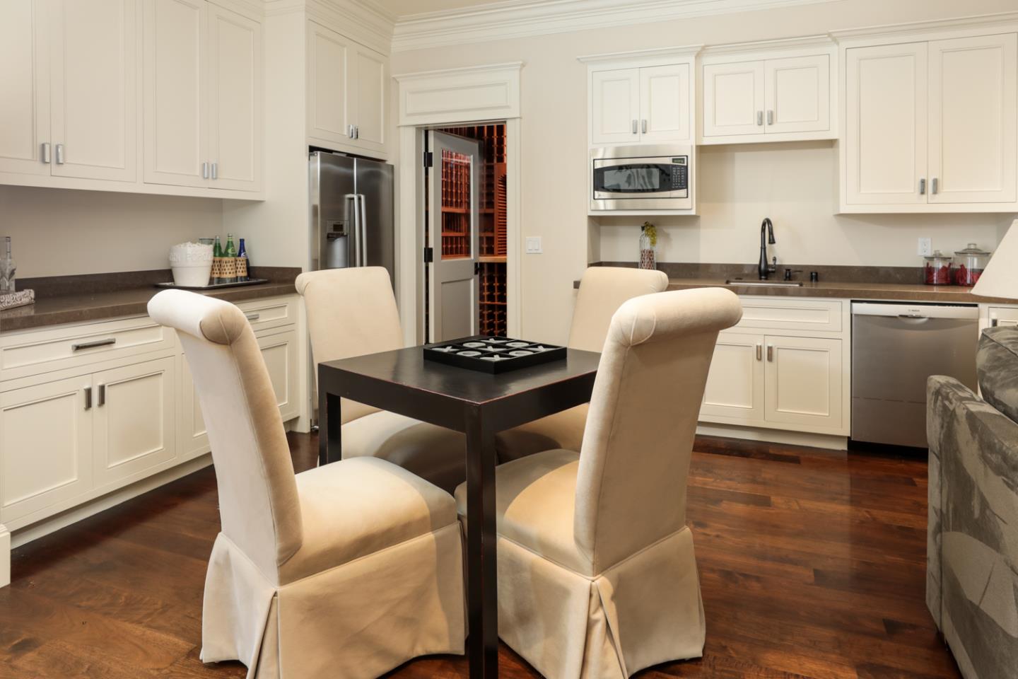 1 Sutherland Drive Atherton, CA 94027 - Photo 3 of 32 a kitchen with stainless steel appliances kitchen island granite countertop a table chairs cabinets and wooden floor
