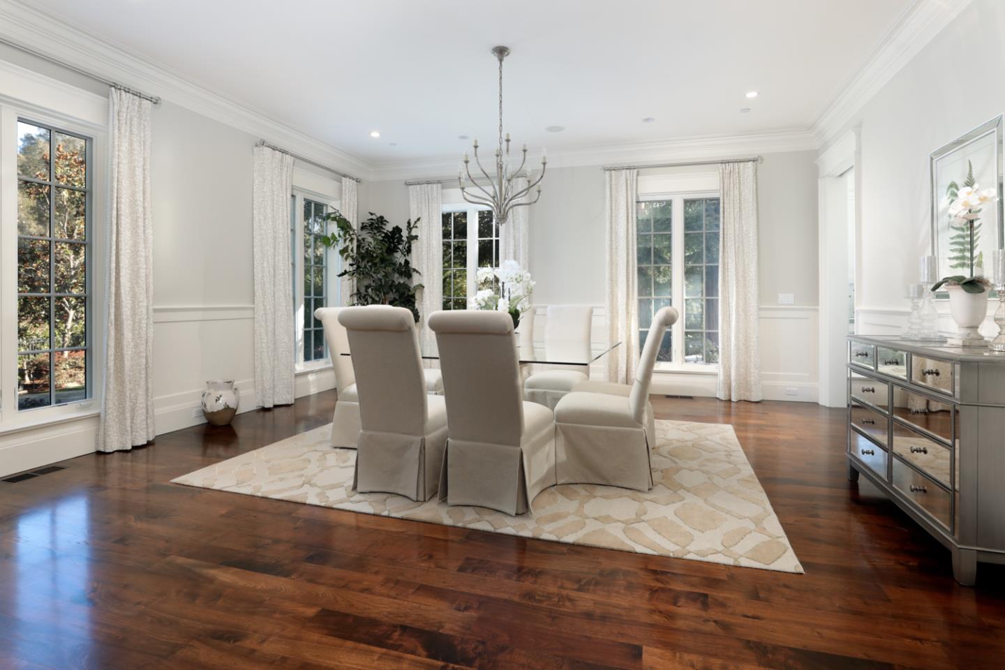 1 Sutherland Drive Atherton, CA 94027 - Photo 5 of 32 a dining room with wooden floor a chandelier a glass table and chairs
