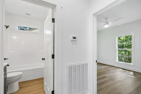 wooden floor in an empty room with a window